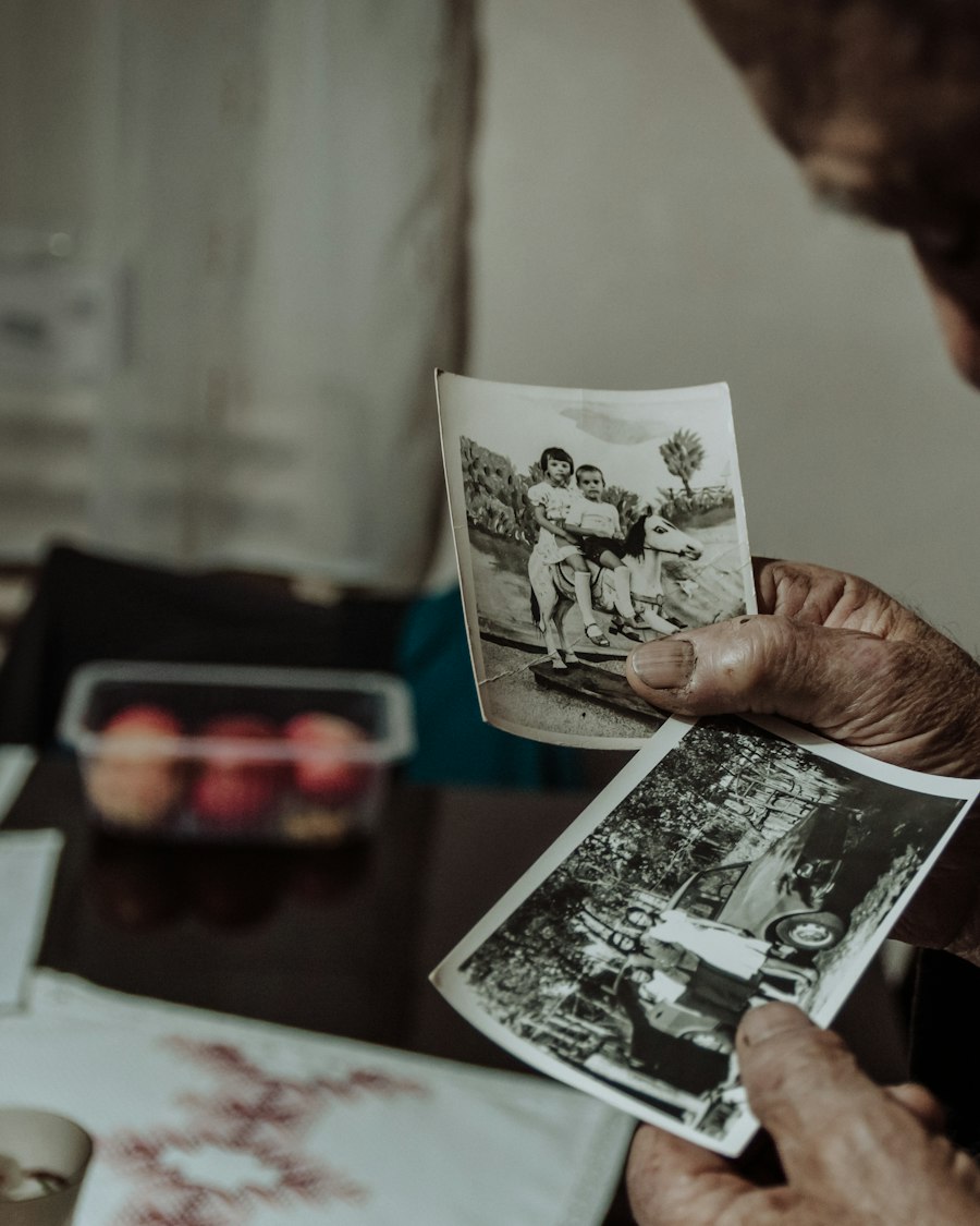 An older man looking through old black and white photographs